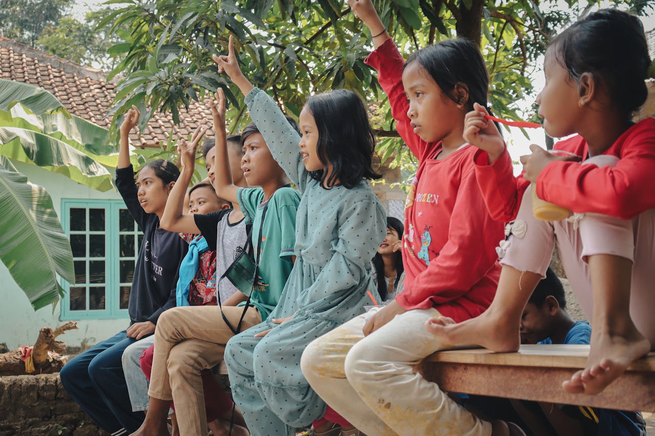 our-story Children participating in a fun quiz in a village setting in West Java, Indonesia.
